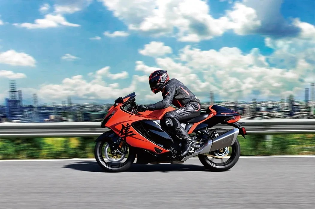 Riding Hayabusa 25th Anniversary in the daytime side on from mountain with cityscape below in background