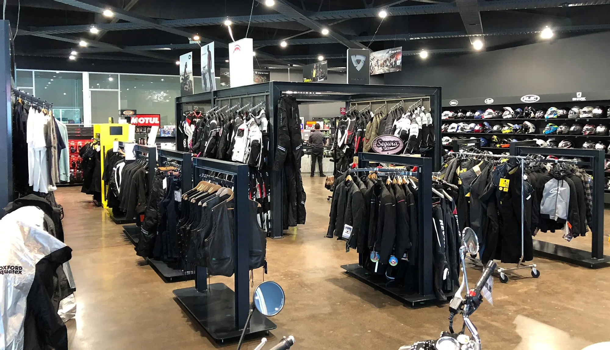 Brisan motorcycles parts and accessories section - wide angle showing range of pants, jackets, helmets and accessories