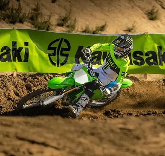 Action image of Kawasaki KX250 2024, roosting out of a berm