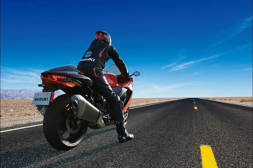 Rider about to take off on Suzuki Hayabusa 25th anniversary deep blue sky