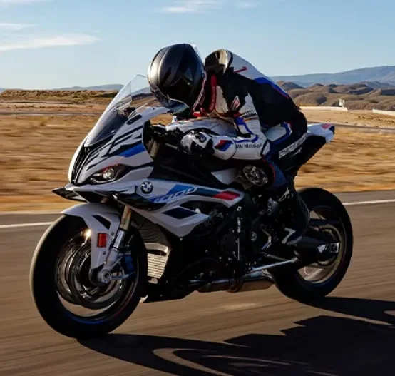 Action image of BMW S 1000 RR M-Sport in Light White Colourway, left three quarter long shot on race track