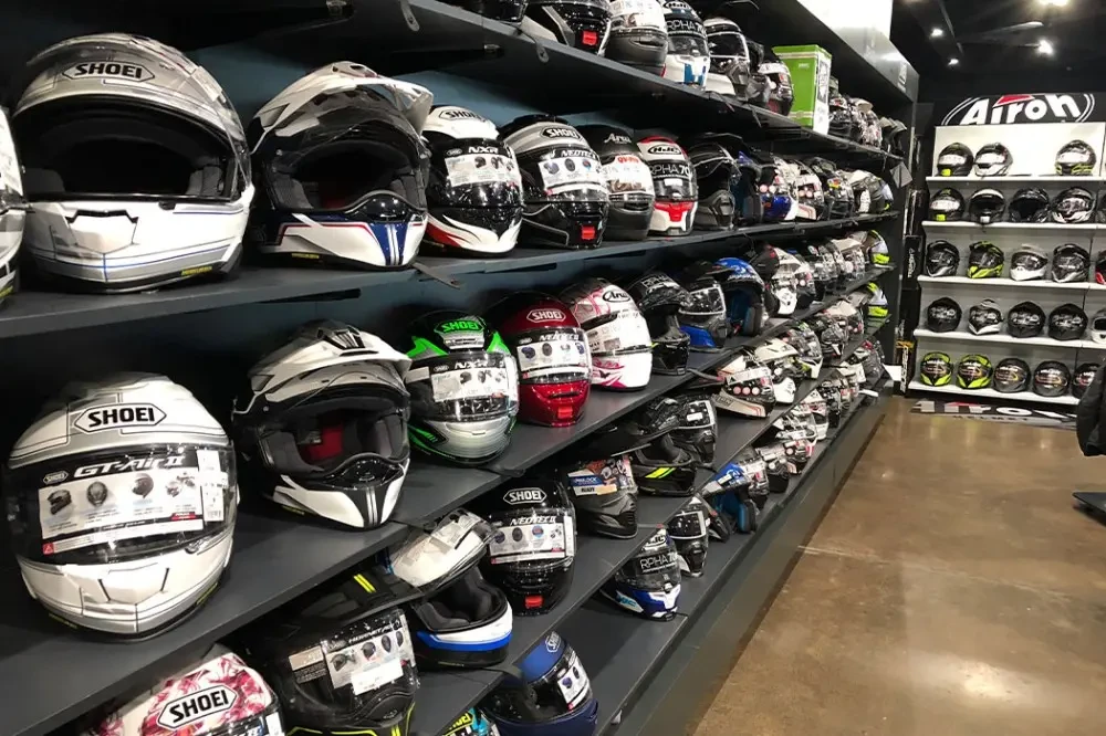 Wall of helmets on display at Brisan Motorcycles Newcastle's parts and accessories area