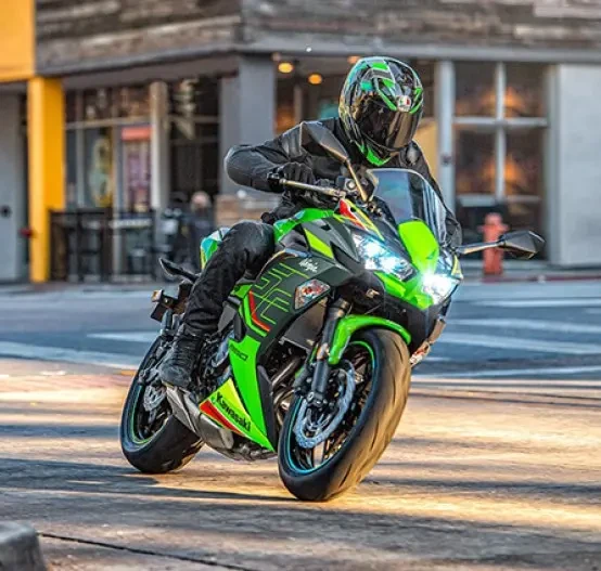 Action image of Kawasaki Ninja 650, mid turn through city intersection