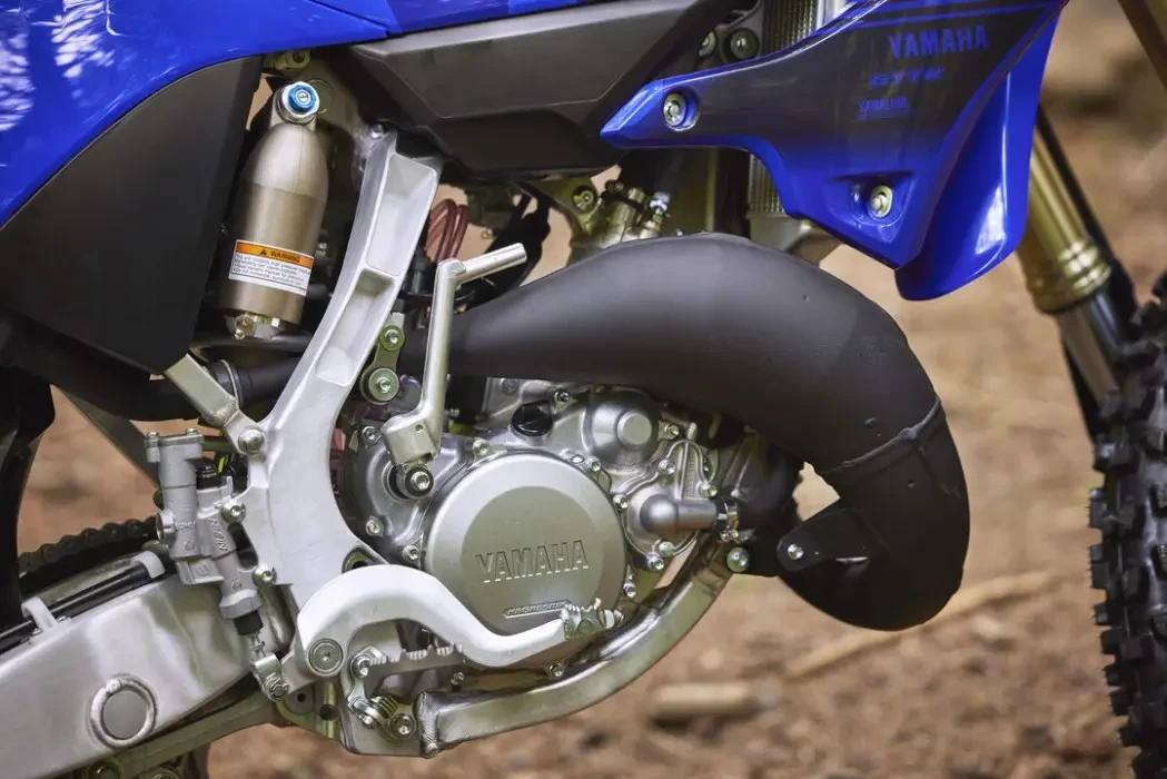 Detail image of Yamaha YZ125X two stroke in blue colourway, engine and exhaust