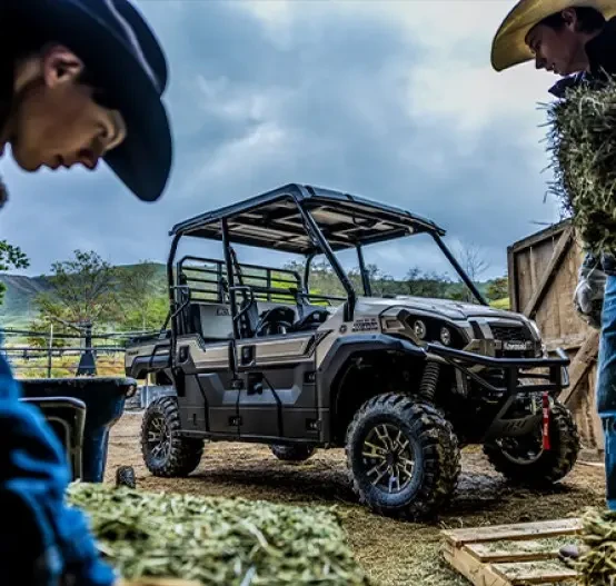 Outdoor image of Kawasaki Mule Pro FXT 1000 Ranch Edition - agricultural setting with farmers, shovels and hay