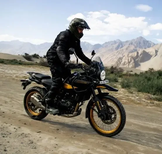 Action image of Royal Enfield Himalayan 450 in Black colourway, off-road adventure riding in mountains