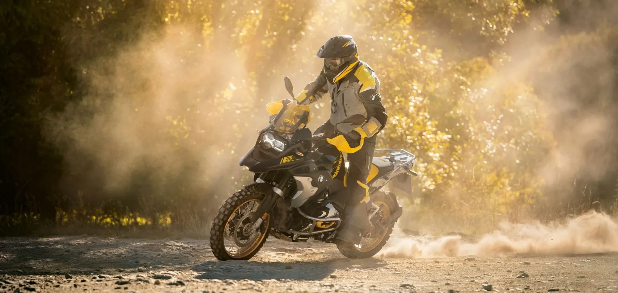 Riding BMW R 1250 GS Triple Black off road with a rear wheel slide